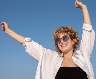 Hands up with a blue sky