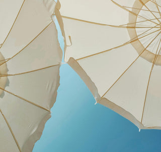 White parasols in summer sunlight