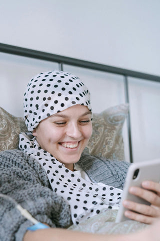 Smiling woman receiving chemotherapy