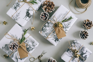 Christmas Gifts and Pinecones on a Gray Surface