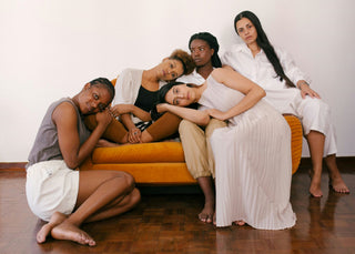 Women sitting on orange sofa