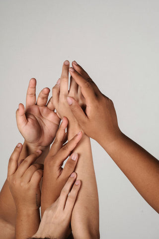 Women put hands together