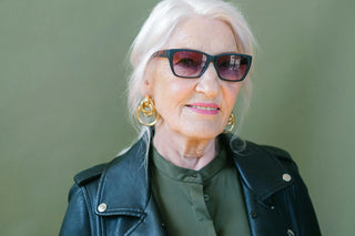 Elderly woman in sunglasses and leather jacket