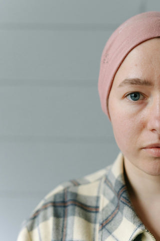 Half face of woman wearing pink bonnet