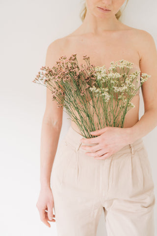 Woman holding delicate flowers